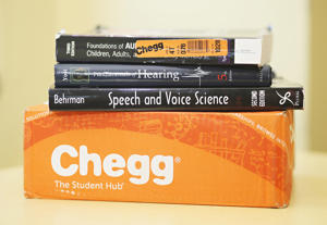 Kay Caprese shows off her Chegg books at the Kent State Library on Monday, Oct. 20, 2016, in Kent County, Ohio. Caprese rents most of its textbooks from an online rental site. (Leah Klafczynski/Akron Beacon Journal/Tribune News Service via Getty Images)