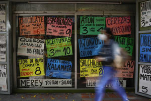 Billboards display the prices of products in US dollars in front of a grocery store in Caracas, Venezuela, last year. The Edelman Trust Barometer survey shows that fewer people believe their families will be better off five years from now. (Matthias Delacroix/Associated Press)