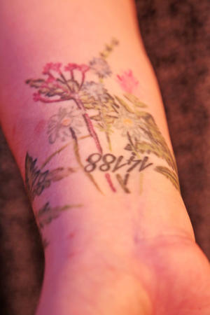 Tiara Herr's forearm tattoo has five flowers, representing the number of times cancer almost killed her and the number 14188, the number of a patient in the hospital.
