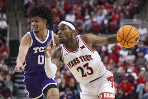 De'Vion Harmon of Texas Institute of Technology (23) drives past TCU's Mickey Peavey (0) during the first half of an NCAA college basketball game on Saturday, Feb. 25, 2023, in Lubbock, Texas. (AP Photo/Chase Seabolt)