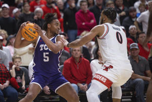 TCU's Chuck O'Bannon Jr. (5) is defended by Texas Tech's Kevin Abanor (0) during the second half of an NCAA college basketball game on Saturday, Feb. 25, 2023 in Lubbock, Texas. (AP Photo/Chase Seabolt)