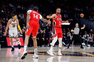 March 30, 2023; Denver, Colorado, USA; New Orleans Pelicans guard CJ McCollum (3) tackles forward Brandon Ingram (14) during the fourth quarter against the Denver Nuggets at the Stadium. Mandatory Credit: Isaiah J. Downing-USA Today Sports