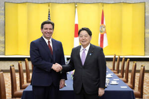 Florida Governor Ron DeSantis and Japanese Foreign Minister Yoshimasa Hayashi shake hands before meeting at the Aikura Hotel in Tokyo on April 24. (Evgeny Hoshiko/AP)