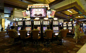 Visitors to the Star Casino in Sydney play electronic slot machines