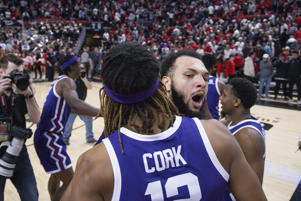 Xavier Cork (12) and Jacoby Coles (21) of TCU celebrate victory over Texas Tech after an NCAA college basketball game on Saturday, Feb. 25, 2023 in Lubbock, Texas. (AP Photo/Chase Seabolt)